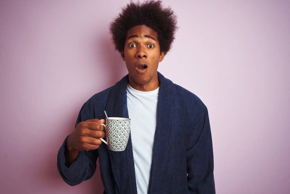 man-with-shocked-face-holding-coffee-mug-