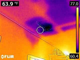 Thermal imaging camera revealing moisture behind walls from ice dam water damage
